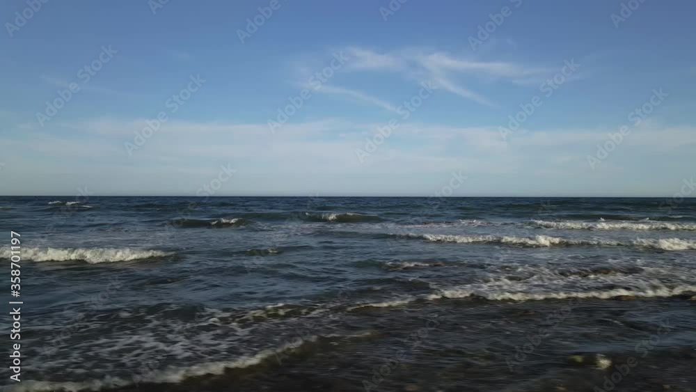 Splashing waves on sunset coastal beach skyline dolly flying left Splashing waves on sunset coastal beach skyline dolly flying left