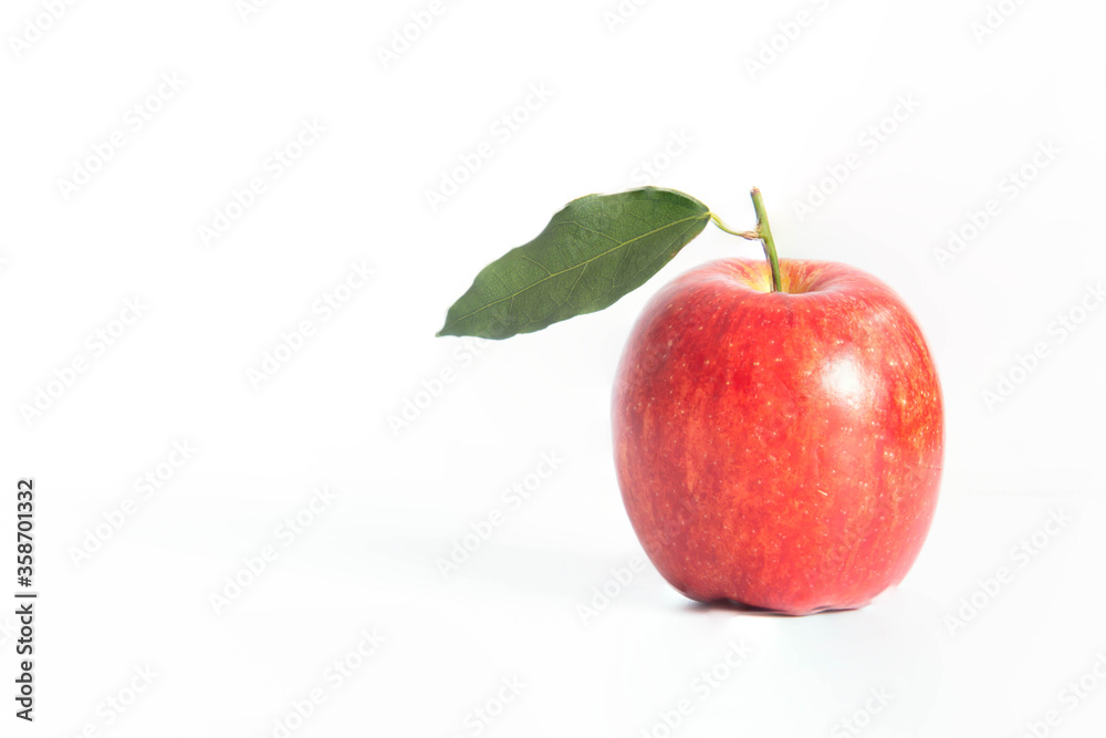 close up of single red apple with leaves close up of single red apple with leaves