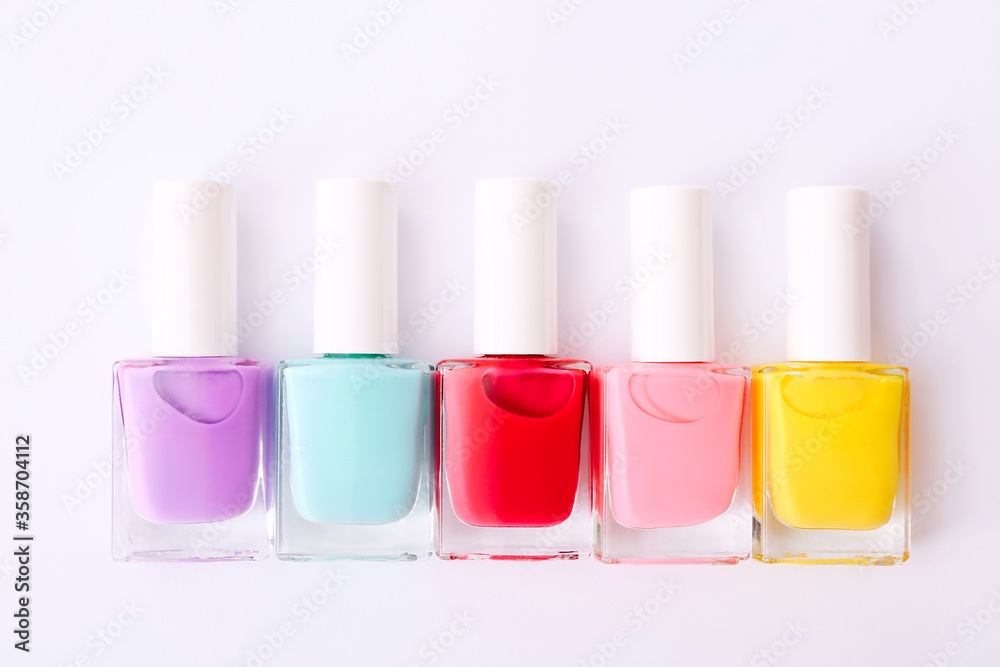 Group of nail polishes of different colors on white background Group of nail polishes of different colors on white background