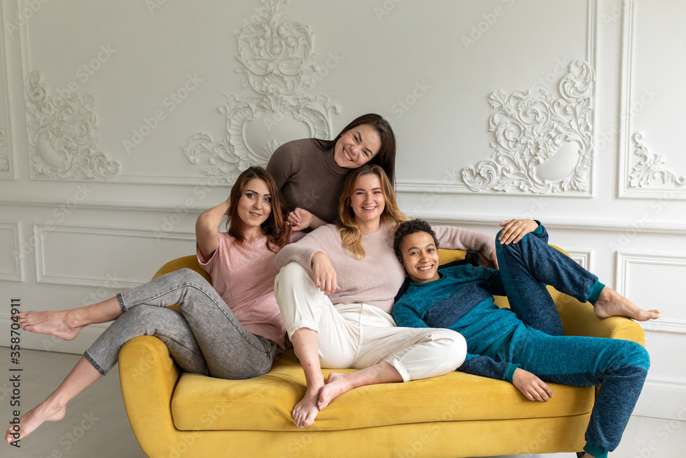 Girl friends at home watching television. Group of women with different body and ethnicity Girl friends at home watching television. Group of women with different body and ethnicity