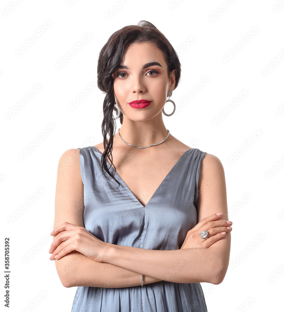 Beautiful young woman wearing stylish jewelry on white background Beautiful young woman wearing stylish jewelry on white background