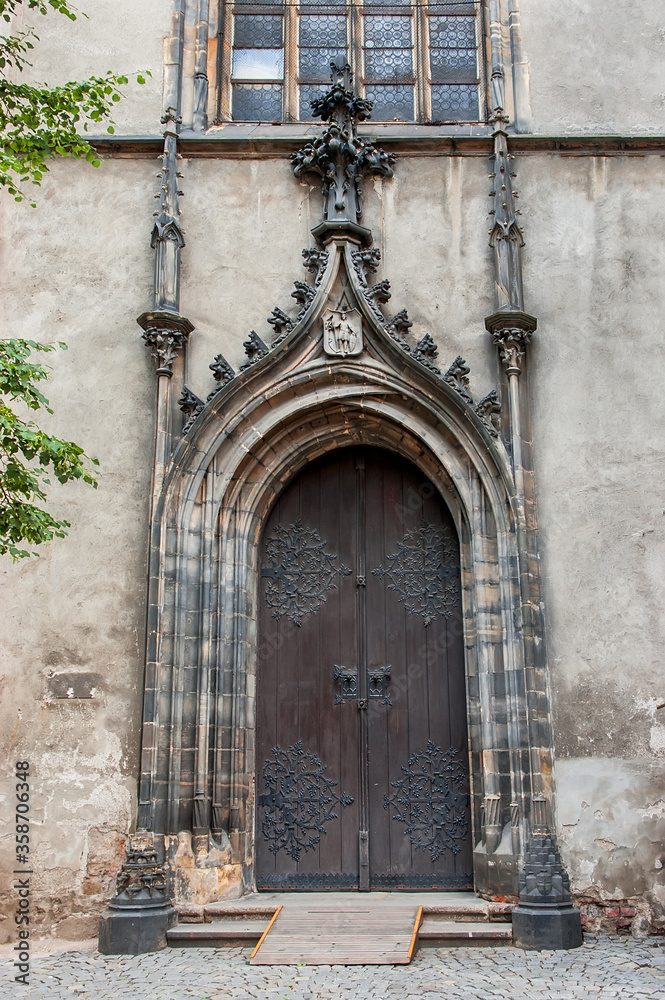 Old church textured door with stone arch facade