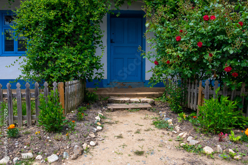 country house with flowers and trees in the yard