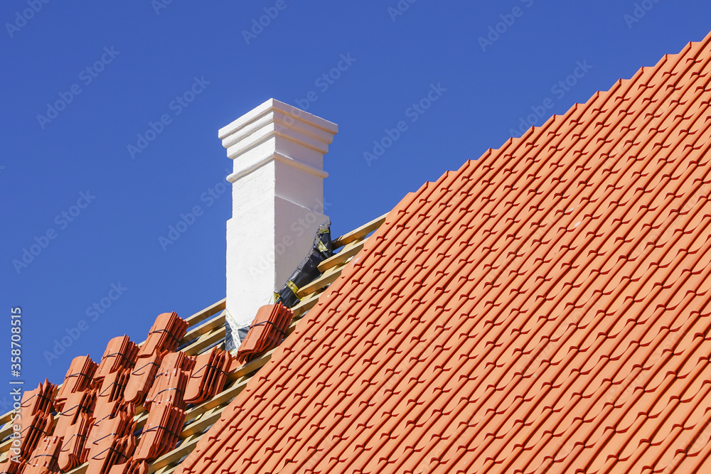restoration of a historic wooden house and replacement of roof clay tiles