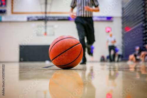 Referee moves toward basketball after a timeout