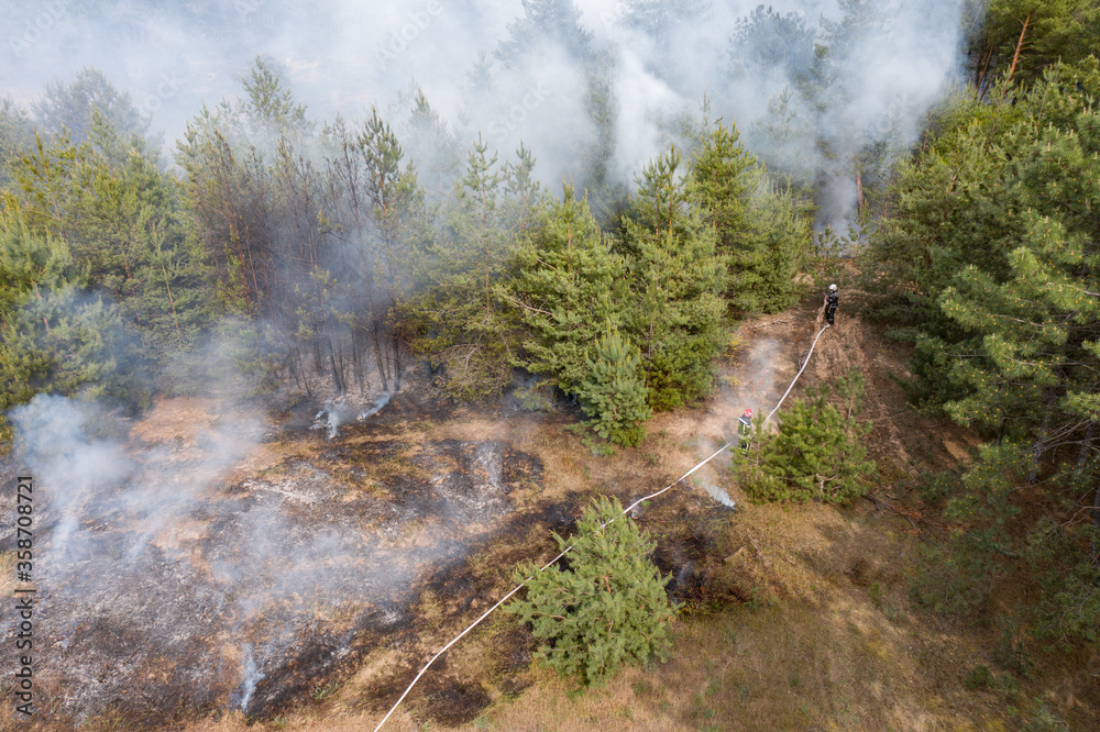 Aerial drone view of a wildfire in forested area Aerial drone view of a wildfire in forested area
