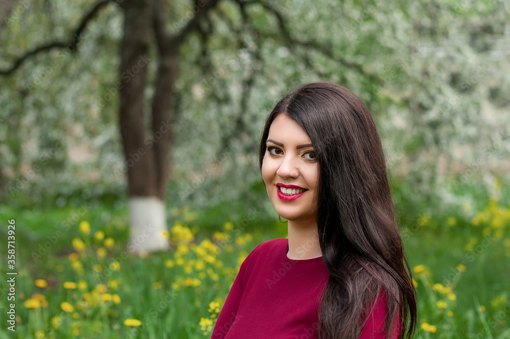 Pretty cheerful brunette woman in the garden Pretty cheerful brunette woman in the garden