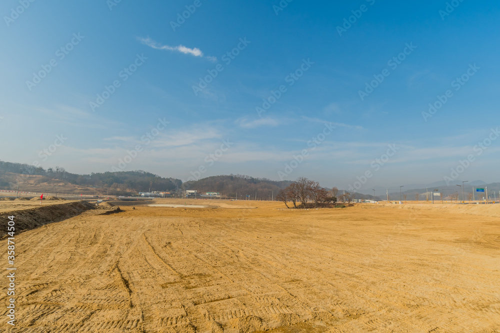 Fototapeta premium Grove of trees at construction site