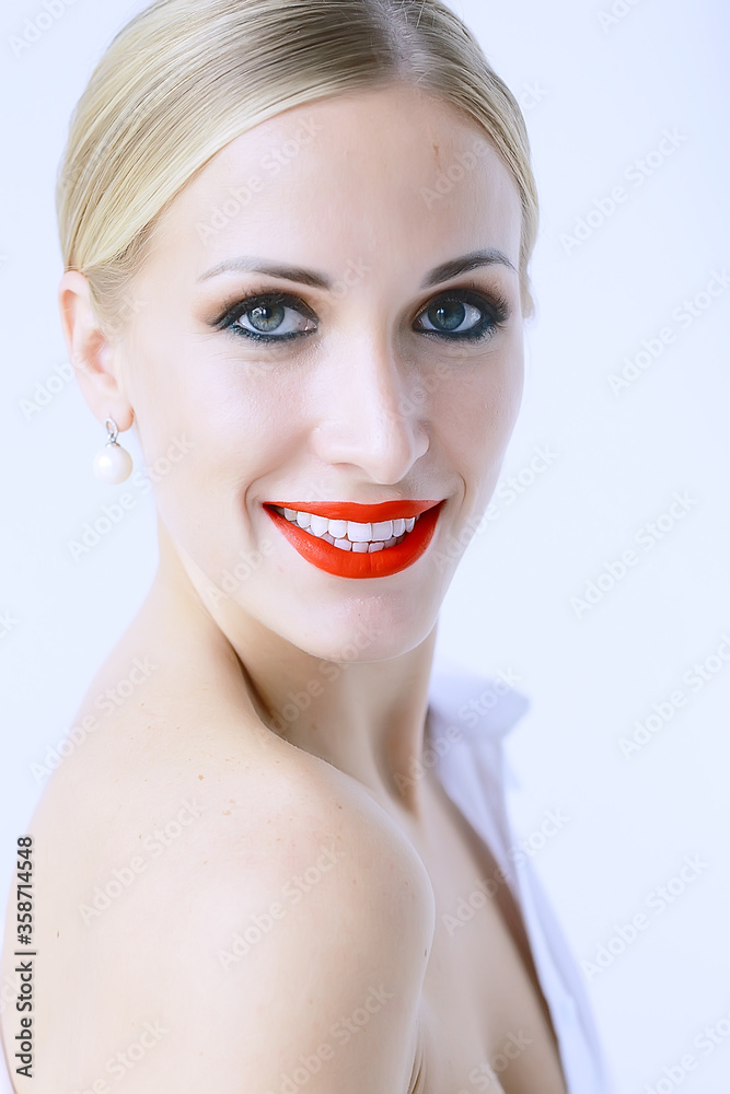 Obraz premium model with professional make-up and bright red lips / beautiful make-up on the face of the model, saturated with bright red lipstick on the lips