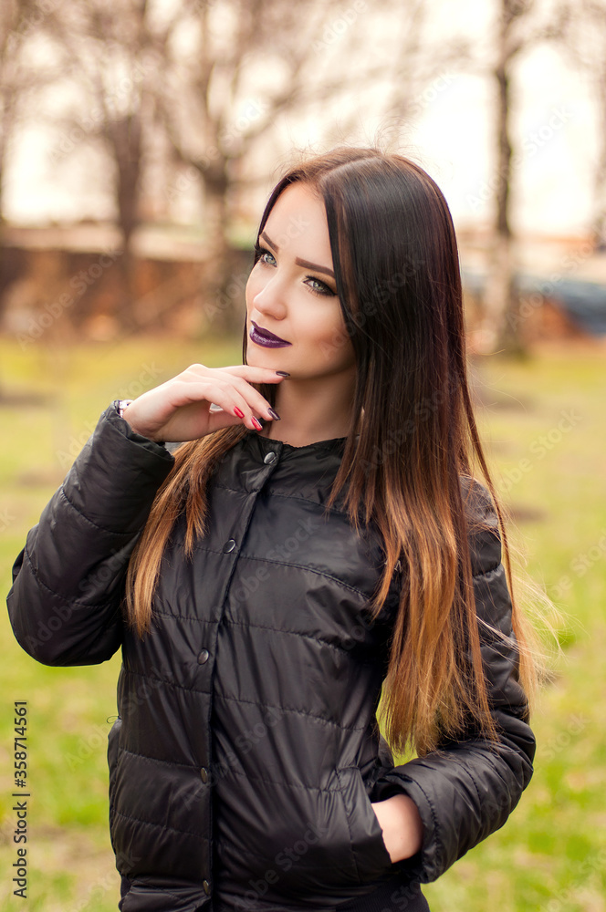Outdoor portrait of young pretty beautiful woman in cold sunny weather in park. Sensual brunette posing and having Outdoor portrait of young pretty beautiful woman in cold sunny weather in park. Sensual brunette posing and having