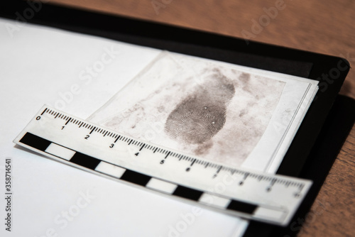 Obraz na płótnie paper ruler and fingerprint on a sheet in the office of the investigator. Fingerprint police uniforms. Forensic-medical examination w salonie