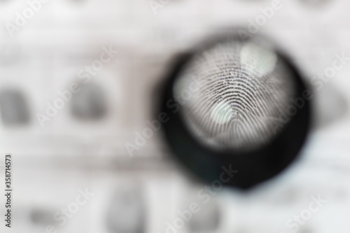 detailed imprint in a police report through a magnifying glass. investigation of a crime. Forensic-medical examination. detective agency.