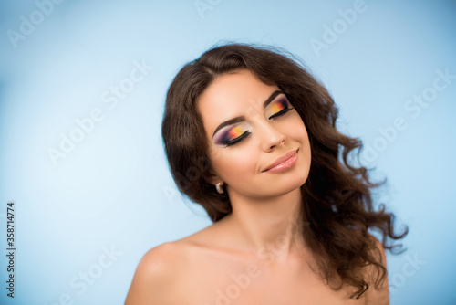 Sensual beautiful curly haired girl with a floral wreath on her head. Fresh skin. Beauty makeup