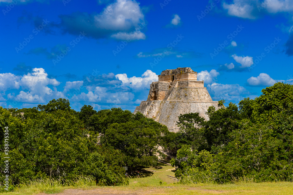 Pyramid of the Magician in the jungle,  a Mesoamerican step pyramid, Uxmal, an ancient Maya city of the classical period. UNESCO World Heritage site
