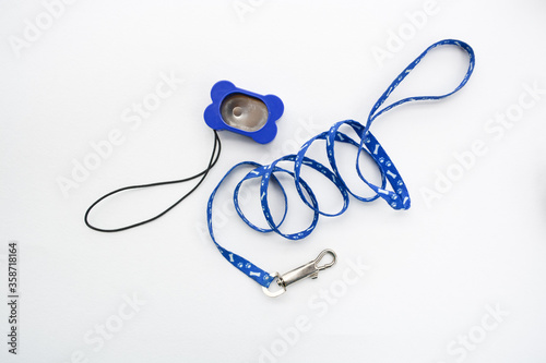 Dog blue accessories, clicker for training and leash, isolated on white background