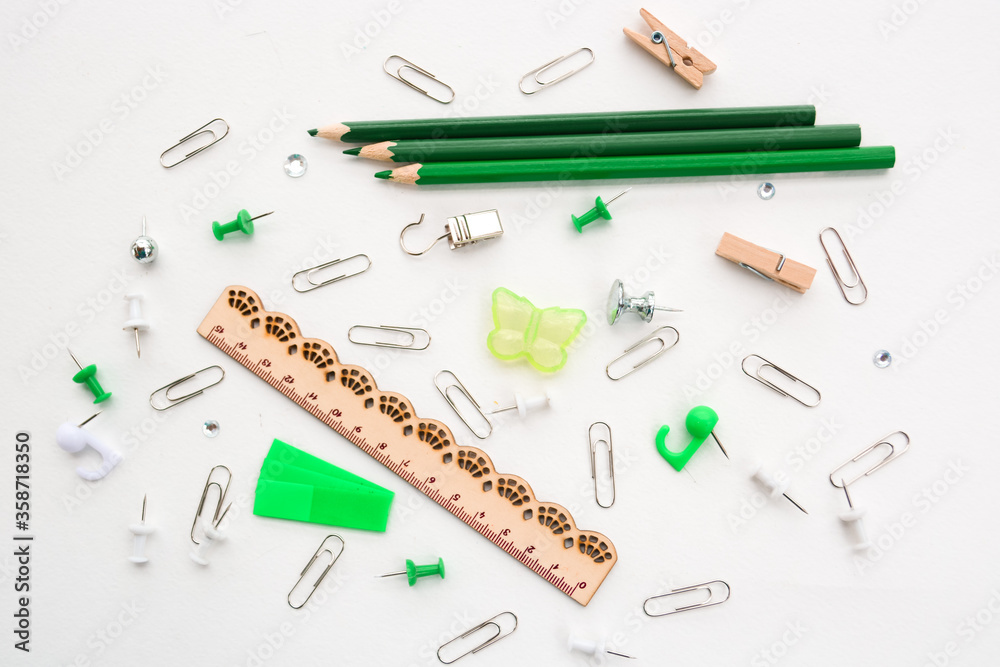 Assortment school or office green stationery, pencils, pins, clips, ruler, isolated on white background Assortment school or office green stationery, pencils, pins, clips, ruler, isolated on white background