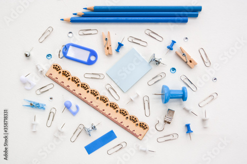 Assortment school or office blue stationery, pencils, pins, clips, ruler, isolated on white background