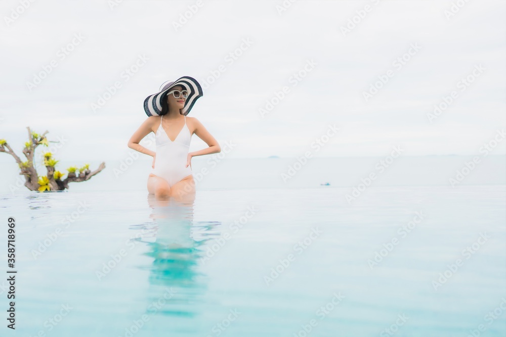 Portrait beautiful young asian woman smile relax and leisure around outdoor swimming pool Portrait beautiful young asian woman smile relax and leisure around outdoor swimming pool