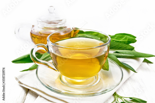 Tea herbal with sage in cup on board