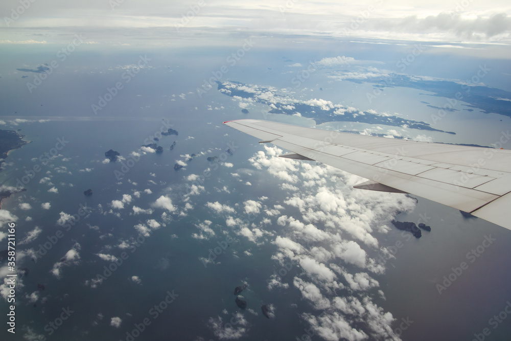 Blue sky with white clouds from the plane view.Cumulus clouds.Krabi Island, Thailand. Blue sky with white clouds from the plane view.Cumulus clouds.Krabi Island, Thailand.