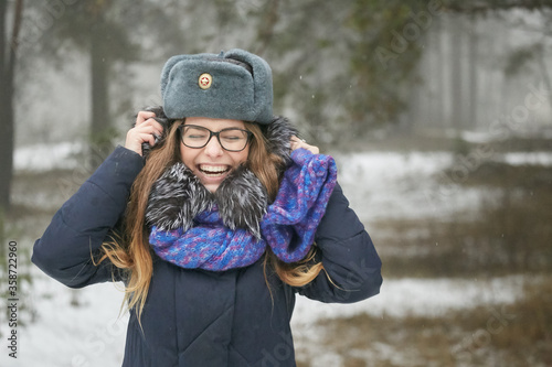 cheerful girl in the military winter hat of the republic of Belarus