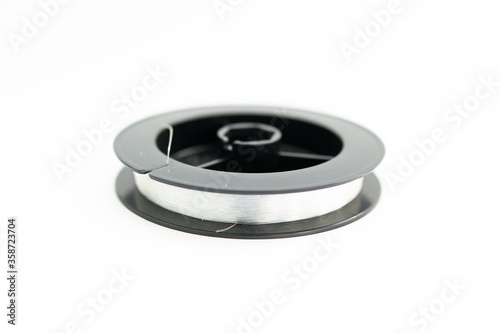 reel with fishing line on a white background