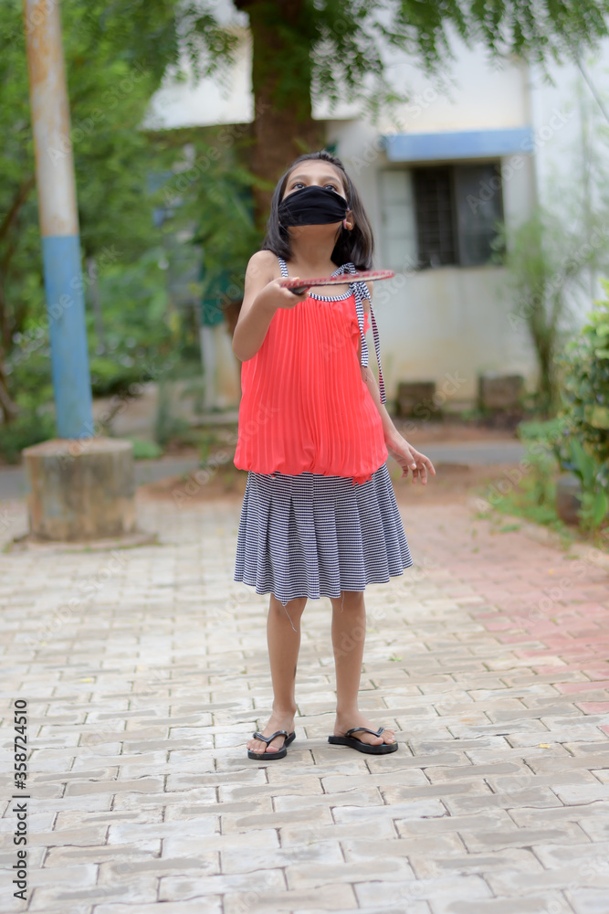 Coronavirus or COVID-19 and Air pollution Little boy playing at outside  and wearing protective medical mask on face for protection from  spreading of disease virus.