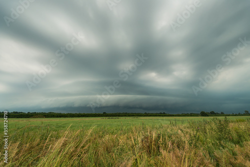 Severe thunderstorm with shelf cloud over the wide dutch landscape