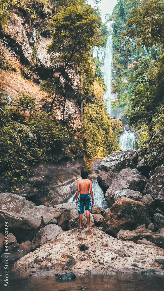 A man stand alone in Agal Waterfall, Sumbawa, Indonesia