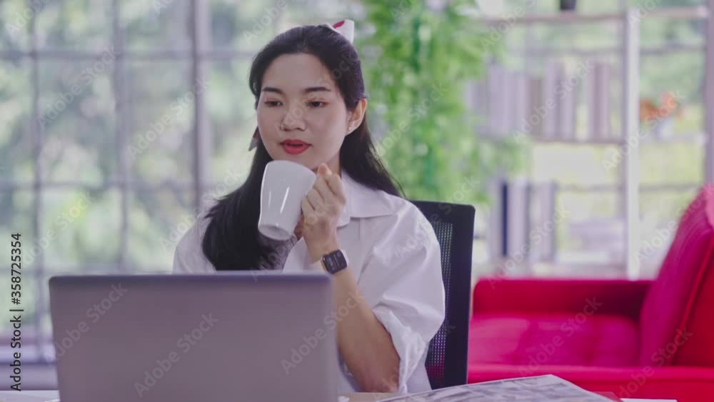 young asian woman working with laptop computer in the living room. Work from home and study at home concept. young asian woman working with laptop computer in the living room. Work from home and study at home concept.