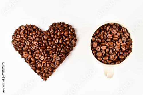 Heart made of coffee beans. Love concept of coffee beans. Isolated on white background. © dharmapocan