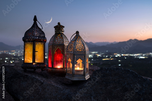 Canvas Print Ramadan lanterns kept on top of the hill against crescent moon with a background of the valley in which the city is illuminated