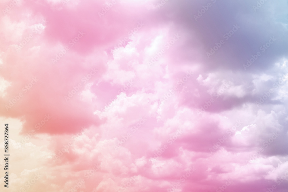 Colorful puffy fluffy cloud & cotton candy cloudscape on sunrise or sunset sky in tropical summer or spring sunlight & sun ray with gradient colors of blue, pink, purple, white & gray, surreal concept