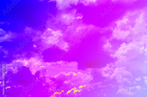 Colorful puffy fluffy cloud & cotton candy cloudscape on sunrise or sunset sky in tropical summer or spring sunlight & sun ray with gradient colors of blue, pink, purple, white & gray, surreal concept