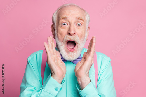 Closeup photo of excited crazy attractive grandpa open mouth listen good news astonished facial expression wear mint shirt suspenders bow tie isolated pink pastel background