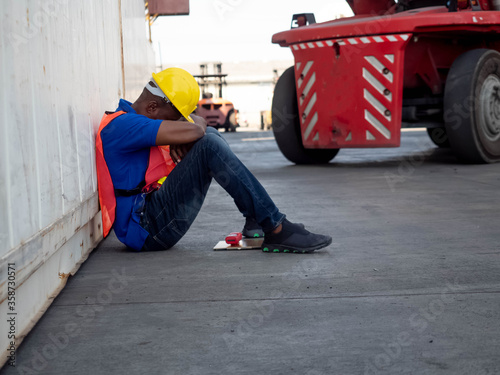 Employment engineer hat yellow and red uniform safety face down because economic business crisis layoff sadness problem bankrupt corona virus disease step down import export international 