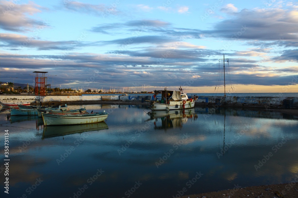 Reflection of boats in a small harbour 