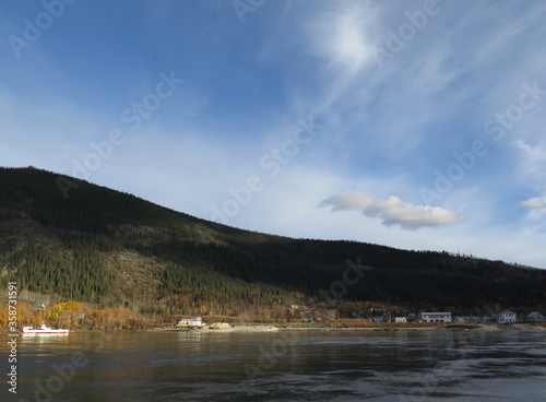 the view from a ferry going from West Dawson to Dawson City in the month of September, Canada