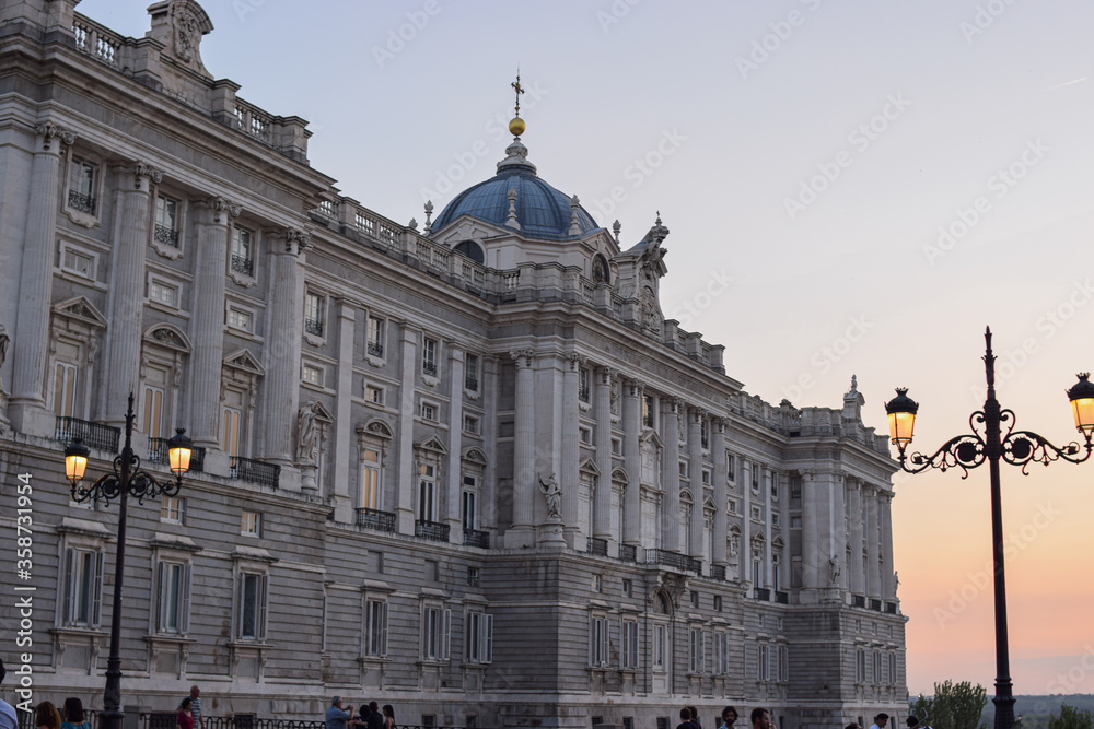 Photo of Royal Palace of Madrid with a carousel during Christmas time and sunset