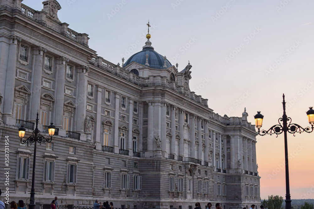 Fototapeta premium Photo of Royal Palace of Madrid with a carousel during Christmas time and sunset