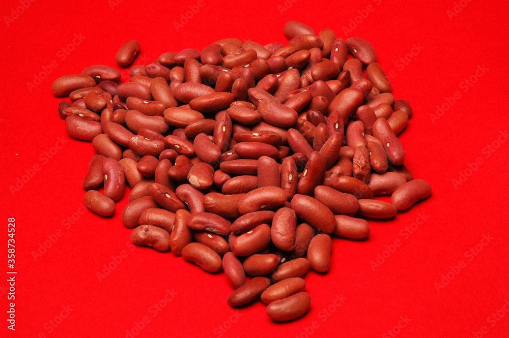 Kidney Beans, Close Up against red background Kidney Beans, Close Up against red background