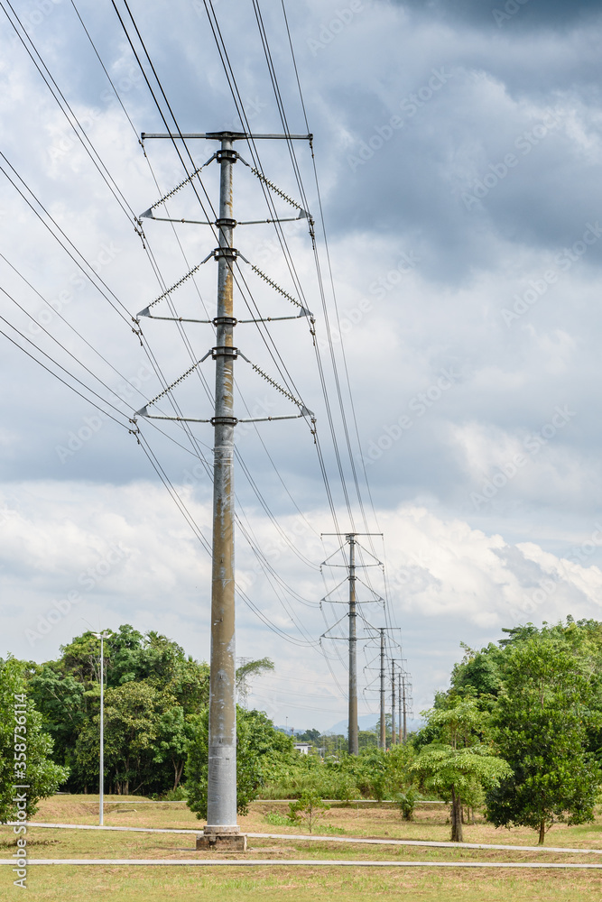 Kuching, Sarawak / Malaysia - June 21, 2016: Power pole and cables in a straight line in daylight.