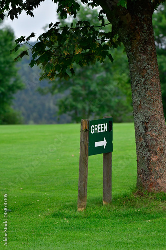 on the golf course with a sign "green"