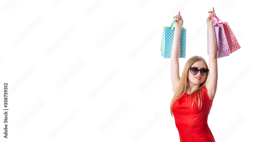 A girl in a bright red dress with colorful bags in her hand after shopping A girl in a bright red dress with colorful bags in her hand after shopping