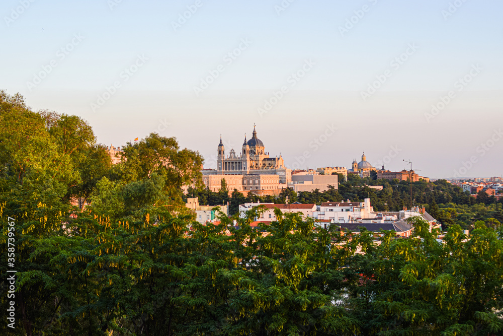 Photo of Almudena cathedral skyline in Madrid surrounded by trees