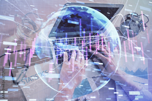 Multi exposure of forex graph with man working on computer on background. Concept of market analysis.