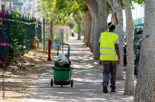 Obraz na plátně street cleaner with trash can and broom