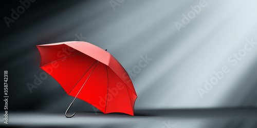 Red umbrella in spotlight.