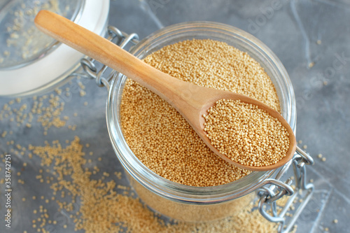 Photos Glass jar of raw Amaranth Grain with a spoon