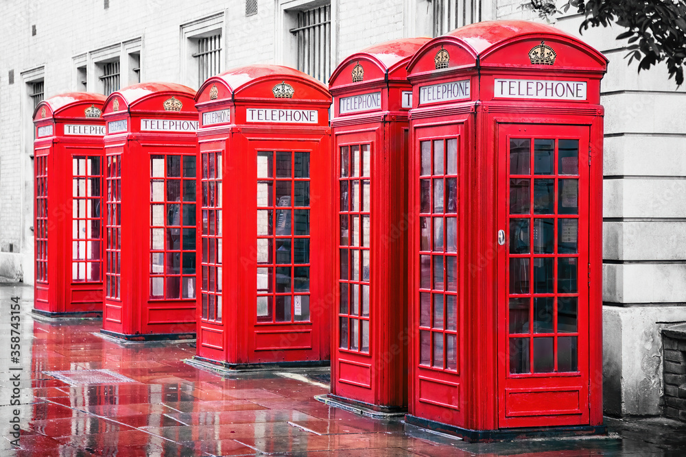 Traditional British red phone boxes in a row in Covent Garden, London Traditional British red phone boxes in a row in Covent Garden, London